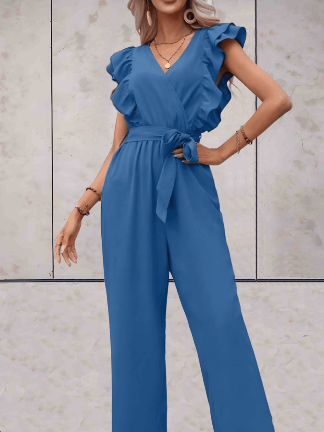 Women's elegant party jumpsuit with a V-neckline and fashionable ruffle sleeves, ready for events.
