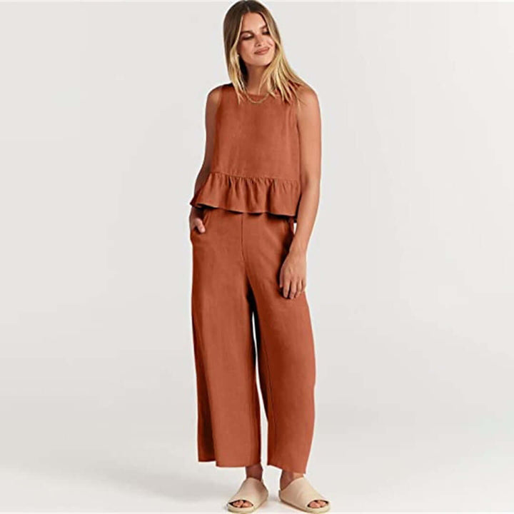 Summer style women's outfit: ruffled sleeveless top with matching wide-leg pants.