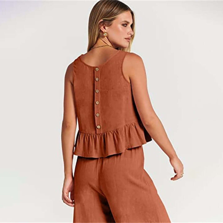 Chic women's ruffled sleeveless top & wide-leg pants set for relaxed spring wear.