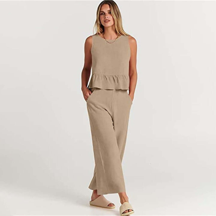 Women's casual outfit with a ruffled sleeveless top and wide-leg pants for comfort.