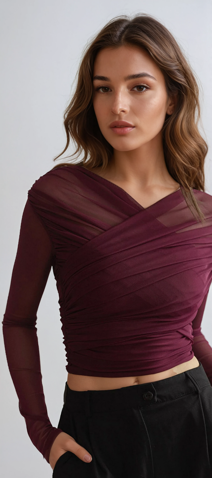 Women's sheer mesh long sleeve top with elegant ruching, perfect for a chic and stylish evening look.