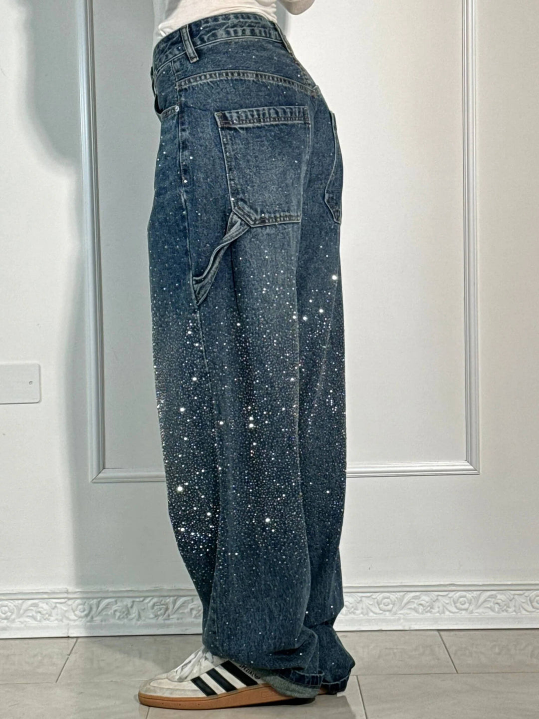 Stylish women's shiny balloon carpenter jeans. Feature statement sparkle and a comfortable relaxed leg.