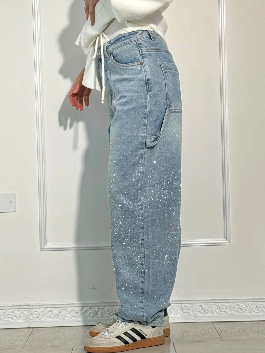 Unique women's shiny balloon carpenter jeans, offering a relaxed fit and statement sparkle for modern style.