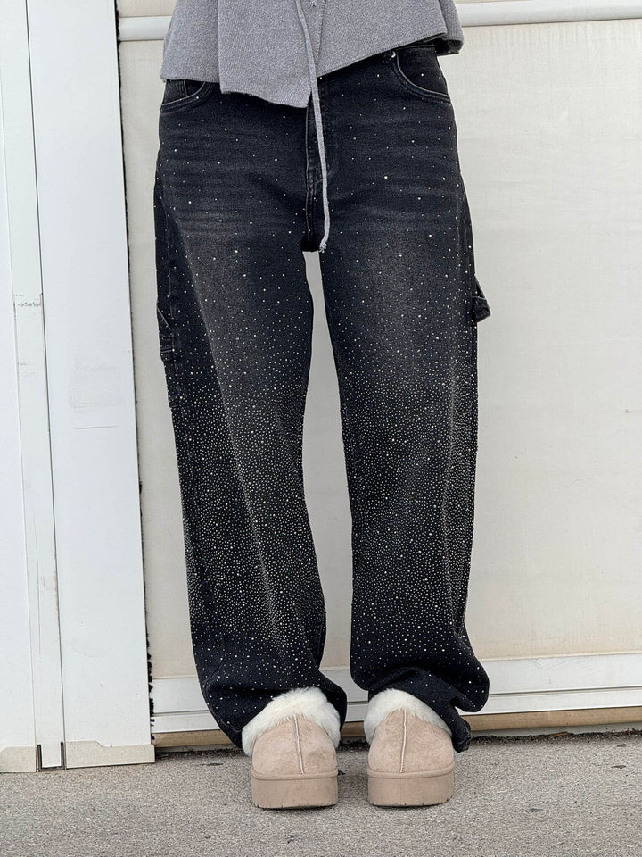 Shimmering women's balloon leg carpenter jeans. Features include a relaxed fit and a distinctive shiny finish.