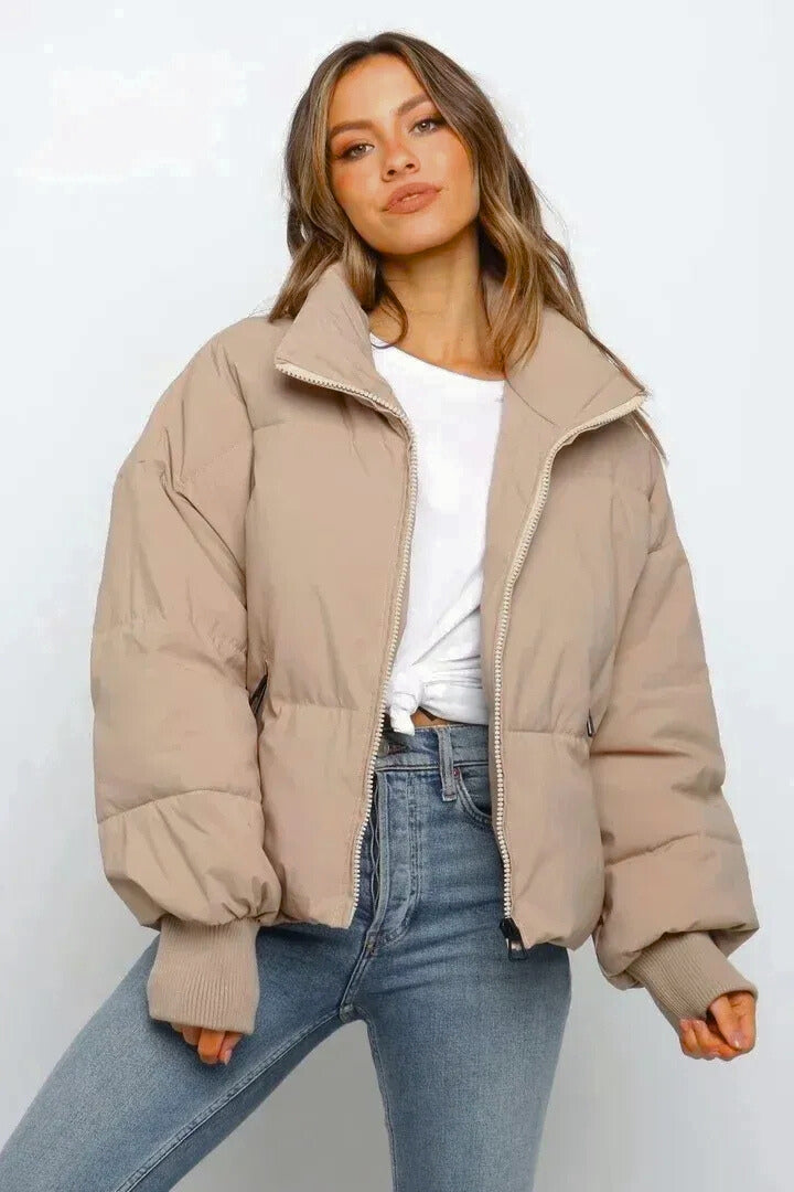 Women's short quilted puffer jacket with zip closure, perfect for winter casual style.
