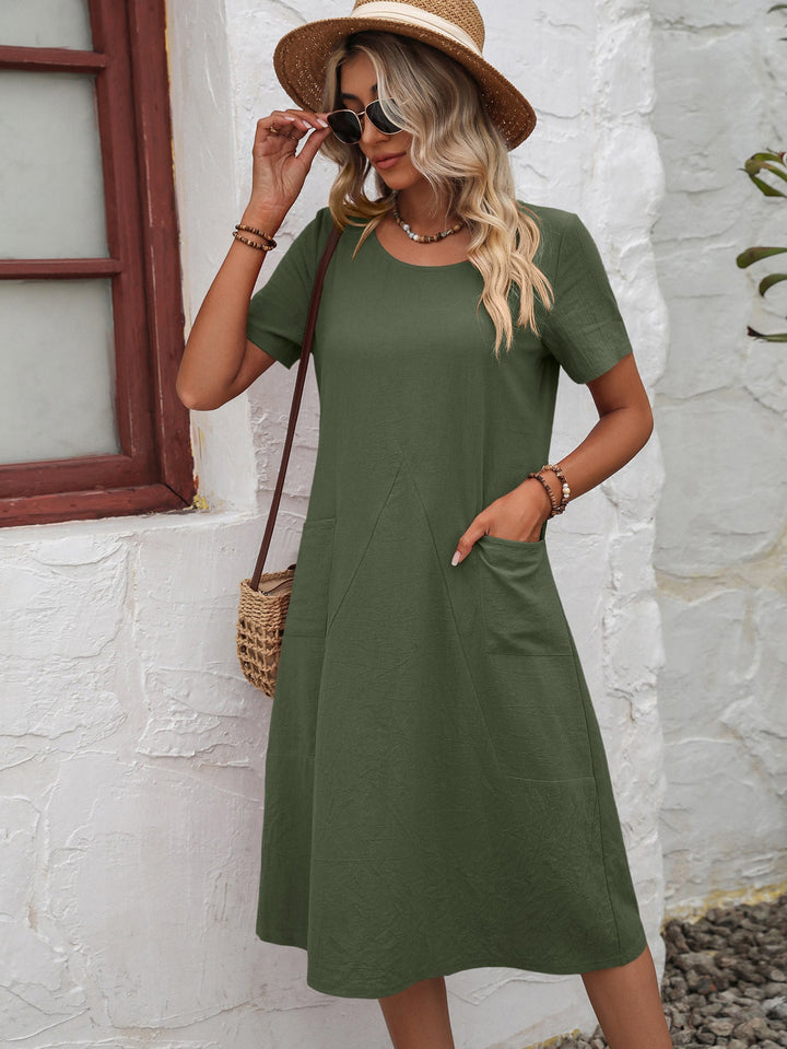 Summer-ready women's short sleeve A-line dress with practical pockets, ideal for a comfortable midi style.