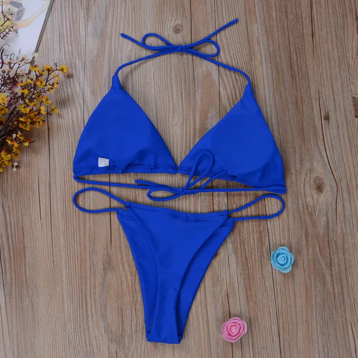 Close-up of a vibrant women's side-tie bikini, highlighting the adjustable design & quality fabric.