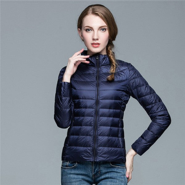 Women's sleek black quilted puffer jacket with stand collar & zip-up front. Perfect for winter outerwear.