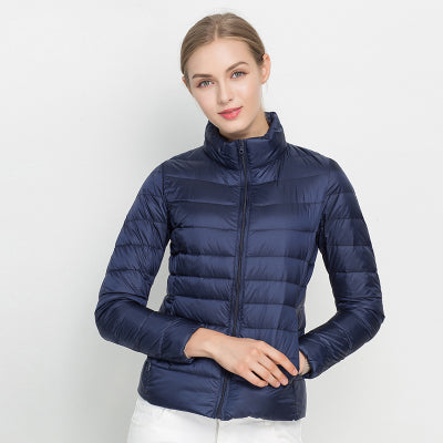 Stylish women's quilted puffer jacket, ideal for fall fashion. Features a stand collar and zip closure.