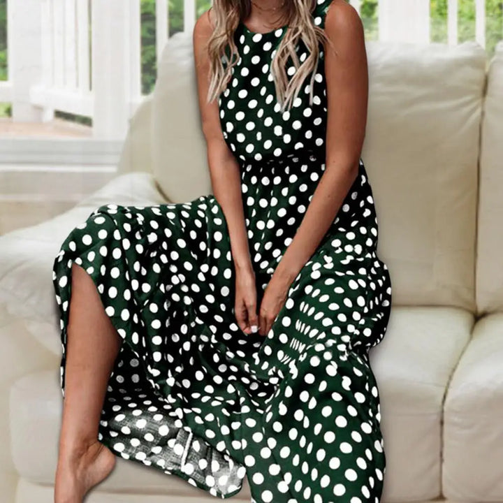 Flowy women's sleeveless polka dot maxi dress with round neck, perfect for elegant vacation style.