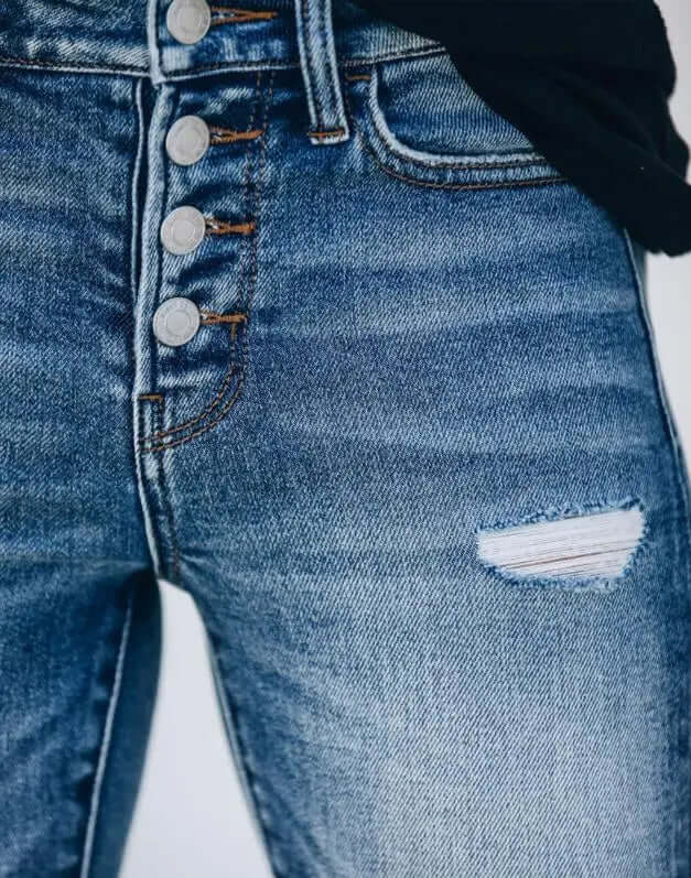 Trendy women's slim fit ripped jeans made from quality distressed blue denim, great for casual and fashion-forward looks.