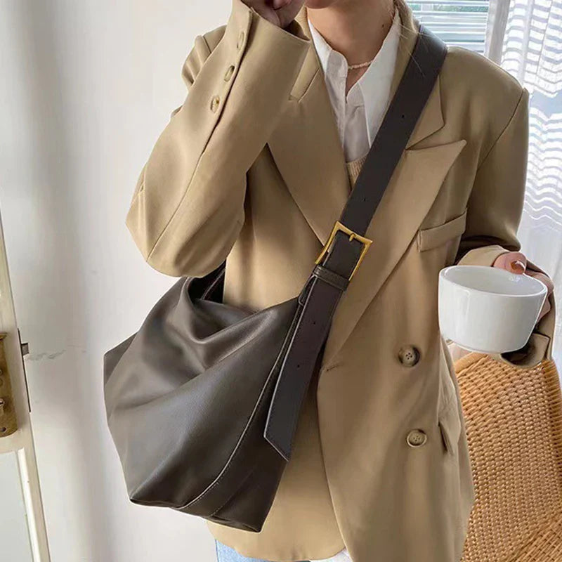 Sleek women's slouchy shoulder tote. This faux leather bag combines modern style with practical large capacity.