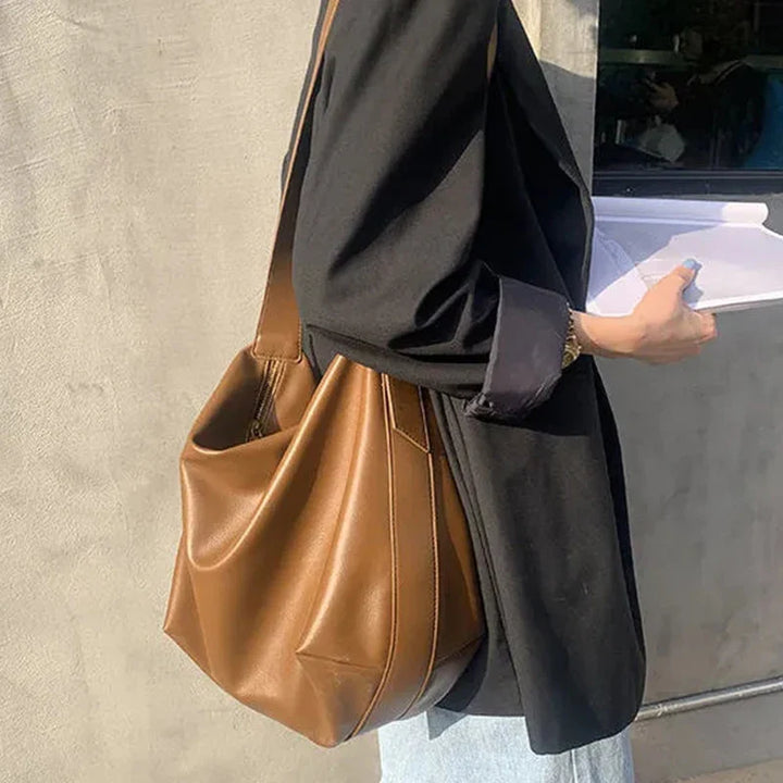 Faux leather slouchy tote bag for women, featuring a comfortable shoulder strap & spacious interior.