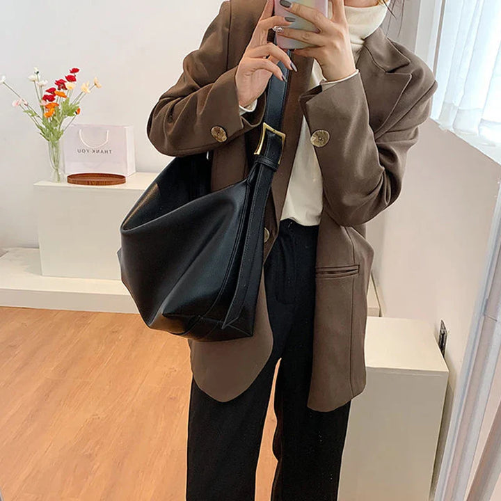 Chic faux leather slouchy tote. This women's shoulder bag offers style and large capacity for essentials.