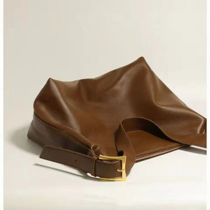 Detail of a women's slouchy shoulder tote bag, showcasing its soft faux leather texture and shape.