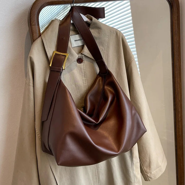 This large capacity women's slouchy tote bag, made from durable faux leather, is a perfect shoulder companion.