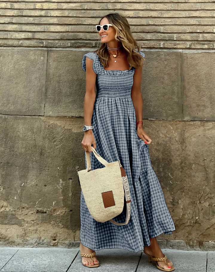 Summer ready women's gingham maxi dress, smocked bodice, flowy skirt, and sweet ruffle sleeves for a chic look.