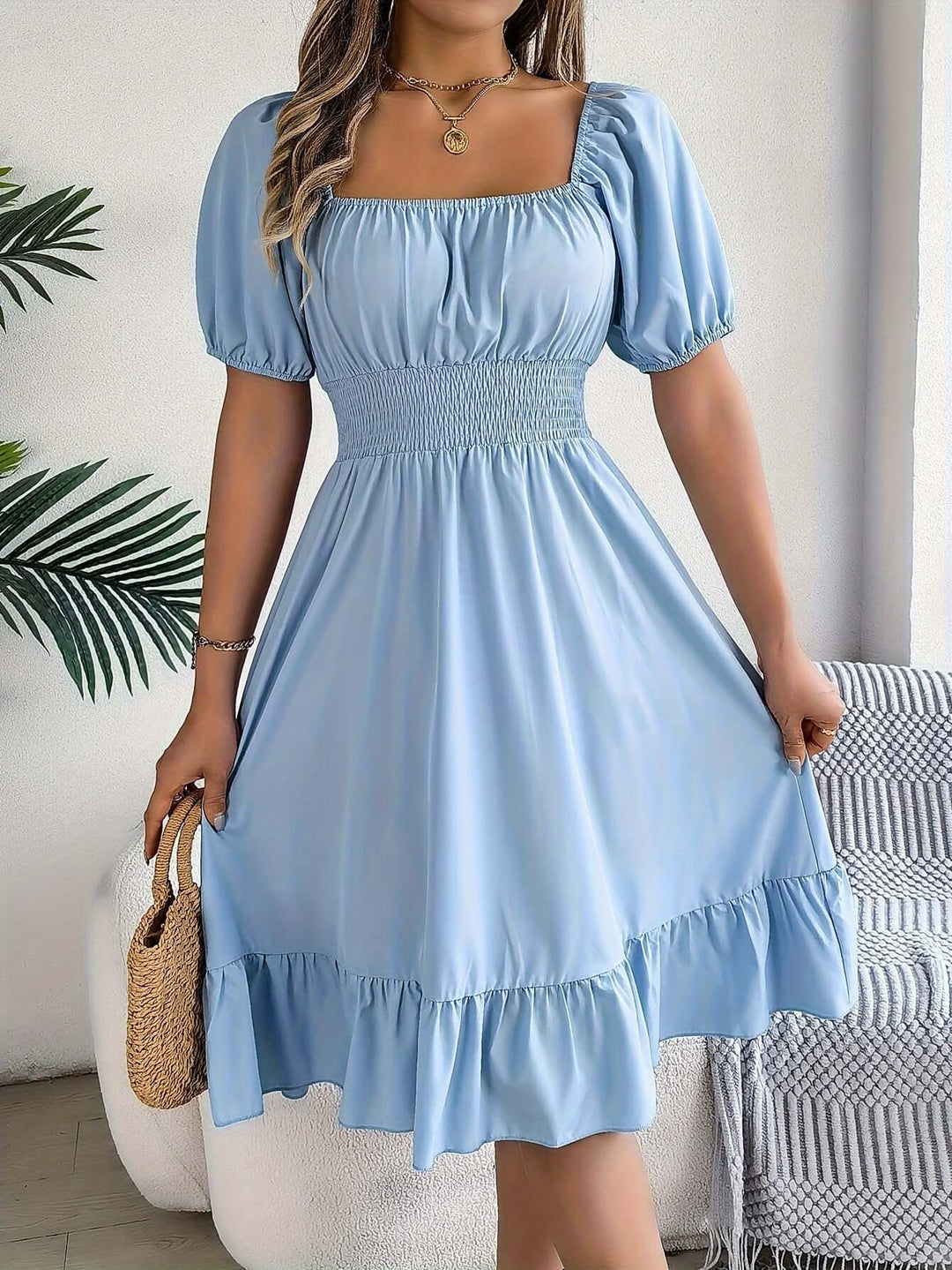 Women's smocked puff sleeve midi dress. A-line rayon blend for summer elegance.