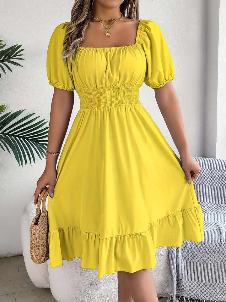 Summer-ready women's smocked midi dress featuring elegant puff sleeves, ruffles, & an A-line cut.