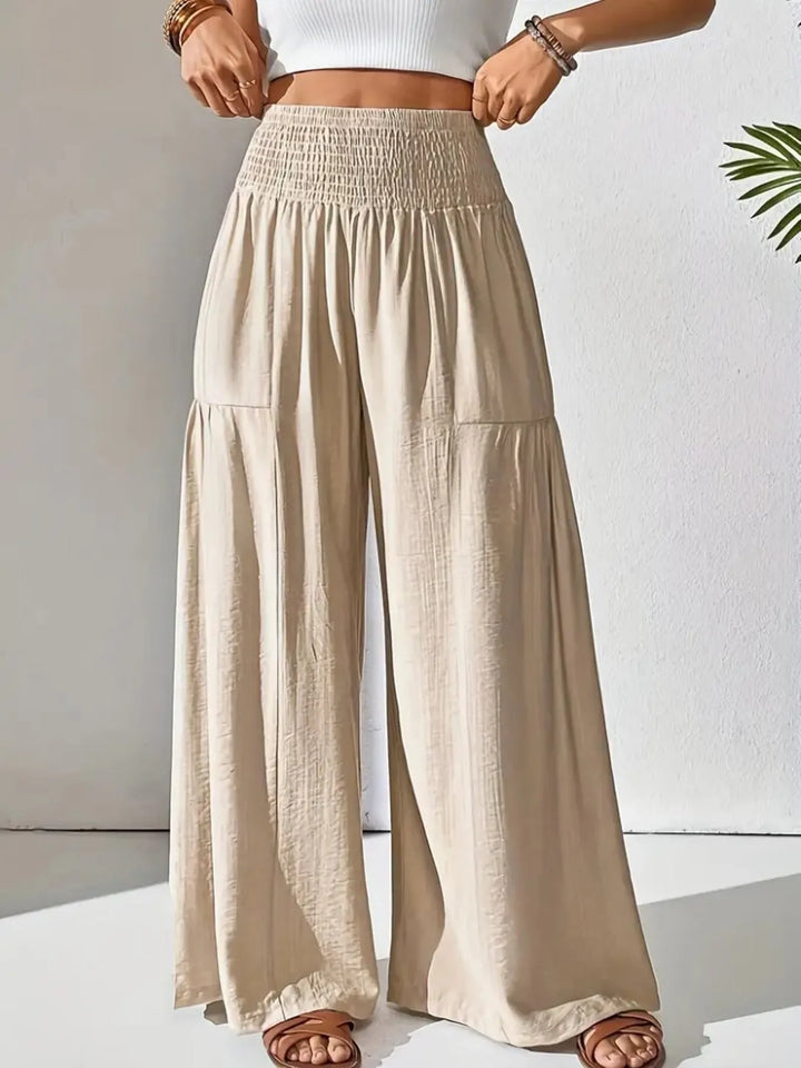 Flowy wide leg smocked waist pants for women, perfect for summer, travel, and comfort.