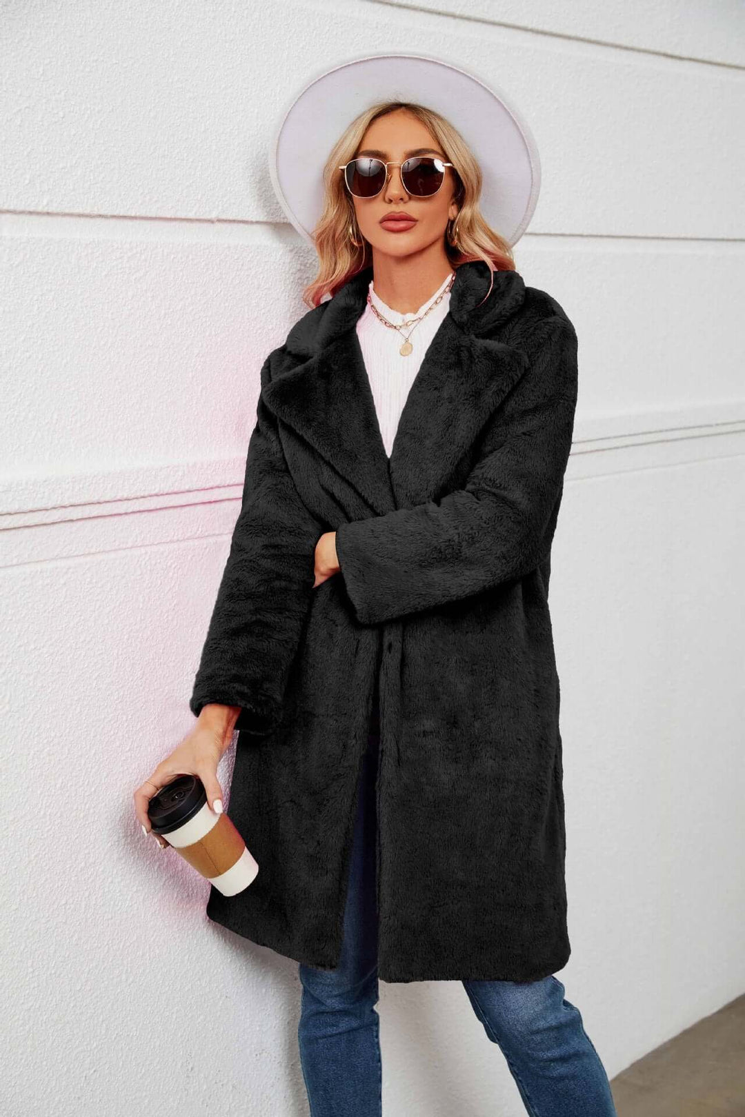Elegant women's long lapel teddy coat in plush faux fur. A chic and warm outerwear option for cold winter fashion.
