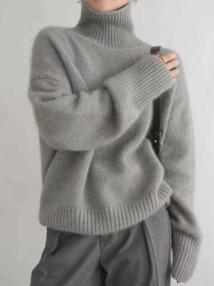 Stylish women's soft knit high neck sweater, a versatile long-sleeve pullover perfect for layering in fall and winter fashion.