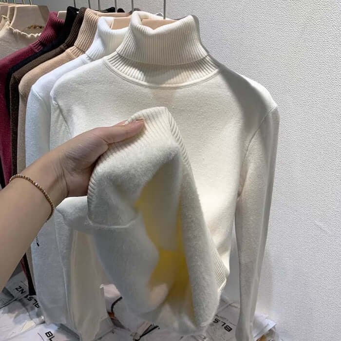 Luxurious velvet turtleneck sweater for women. Long-sleeve, soft, and warm for stylish winter outfits.