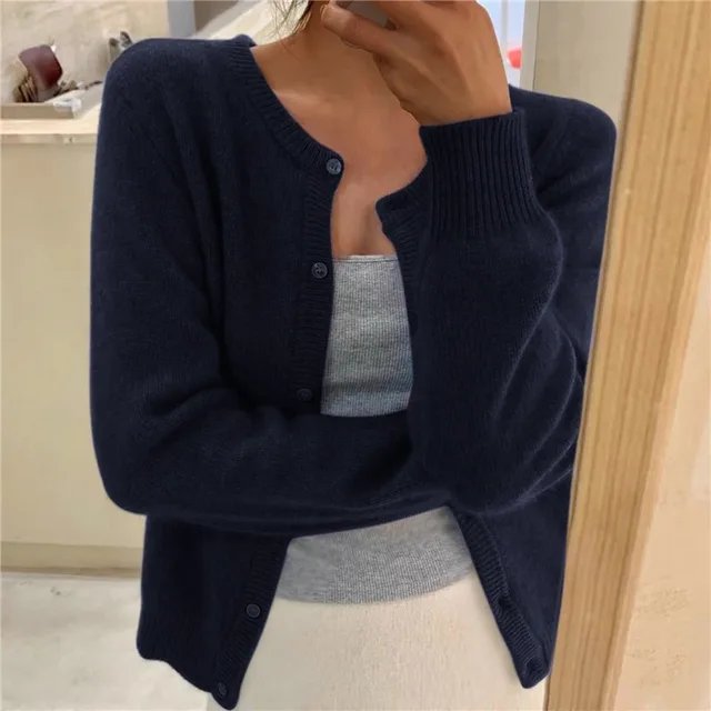 Women's solid knit cardigan, elegant & comfortable for versatile layering.