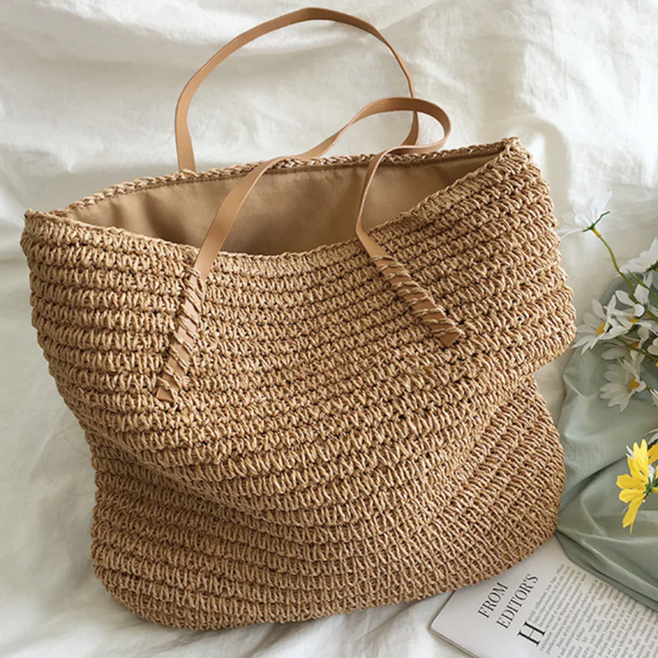 Women's spacious brown handbag with intricate woven pattern and a comfortable, sturdy strap.
