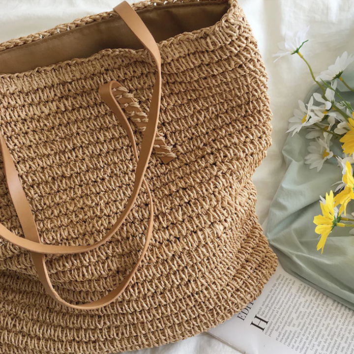 Close-up of the unique TerraWoven texture on a women's spacious brown handbag.
