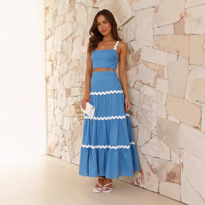 Women's strapless crop top & tiered maxi skirt set. Elegant two-piece summer outfit for vacation wear.