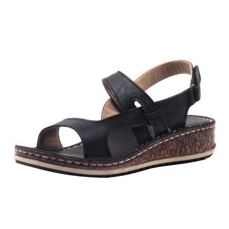 Elegant women's fashion wedge sandals, cork-look sole, and intricate strappy upper