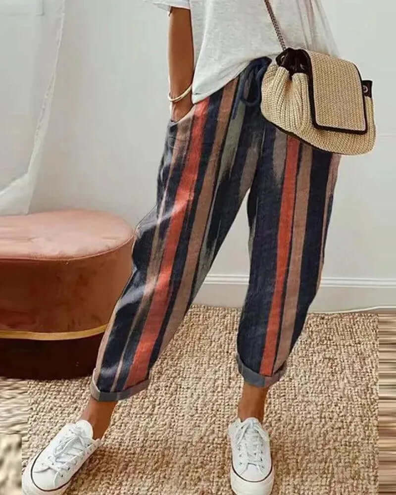 Women's striped linen-blend casual trousers with drawstring waist; comfortable, relaxed fit for summer fashion.