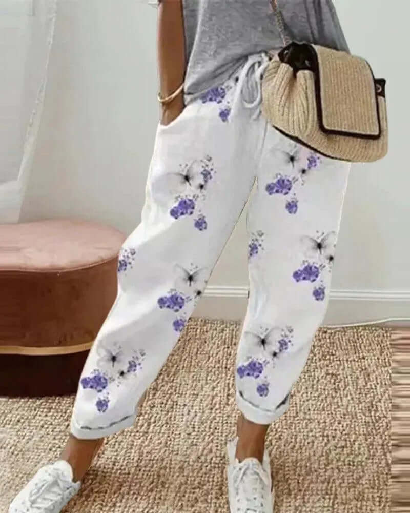Striped linen-blend women's casual pants featuring a relaxed fit & drawstring waist, ideal for summer comfort.