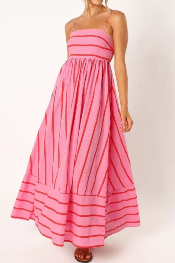 Casual women's striped beach maxi dress with strappy details, perfect for summer vacation.