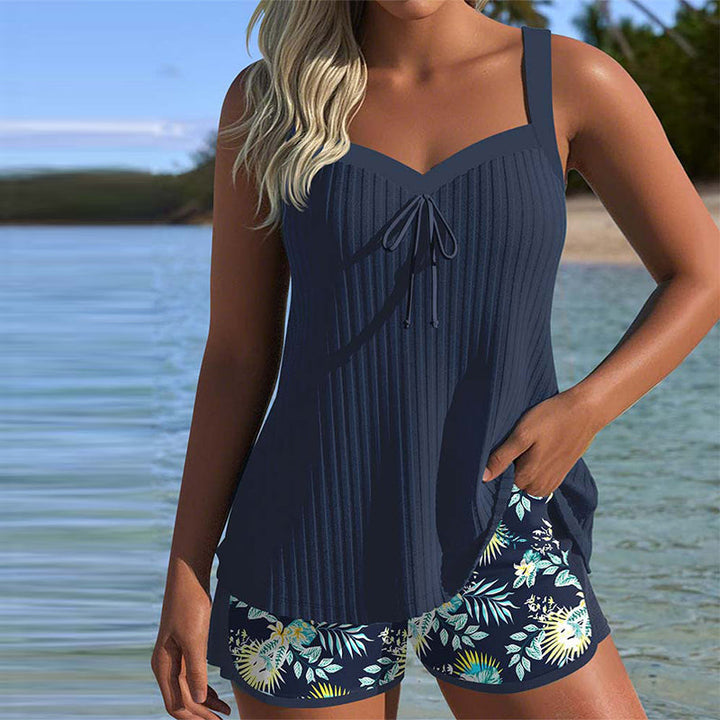 Women's striped tankini set with beach shorts, perfect two-piece swimwear for summer vacation.