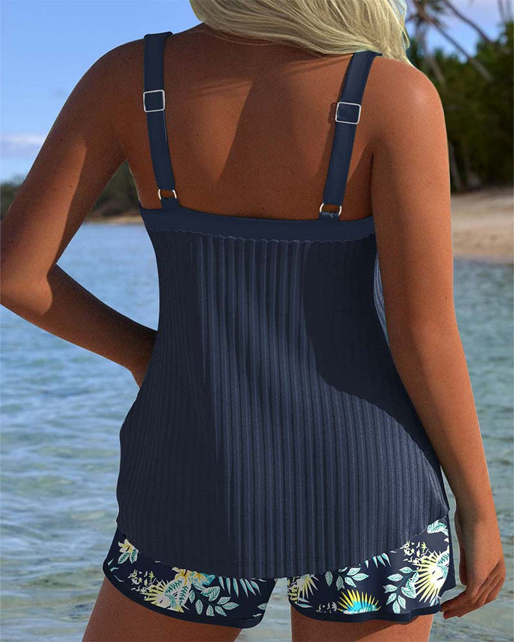 Flattering striped tankini top for women, part of a two-piece swimsuit set with comfortable beach shorts.