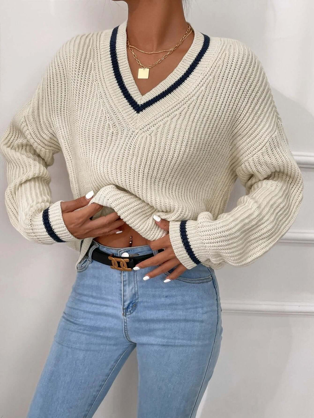 Chic women's striped V-neck sweater, a relaxed fit pullover ideal for winter fashion.