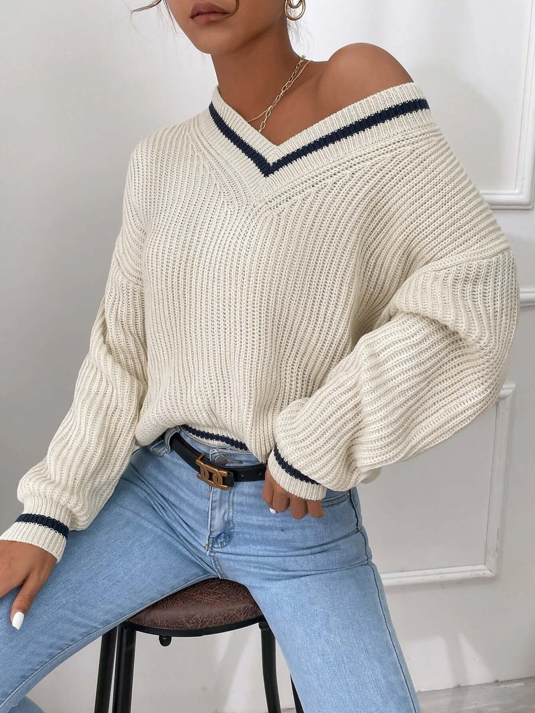 Casual women's striped V-neck sweater, offering a relaxed fit for chic daily outfits.