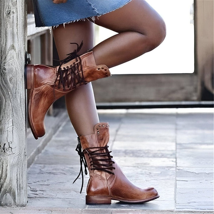 Stylish women's studded lace-up mid-calf boots, ideal casual footwear for autumn and winter outfits.