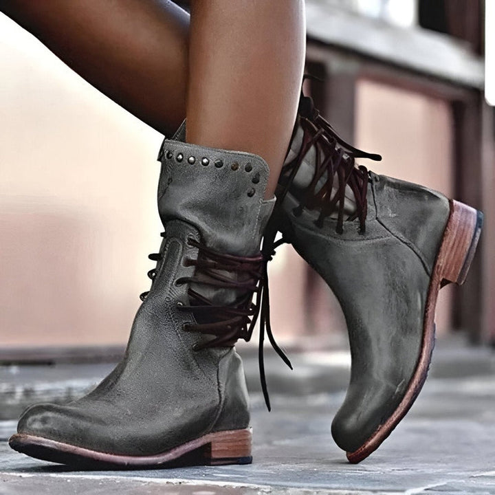 Fashionable women's black studded lace-up mid-calf boots with a comfortable low heel, suitable for daily wear.