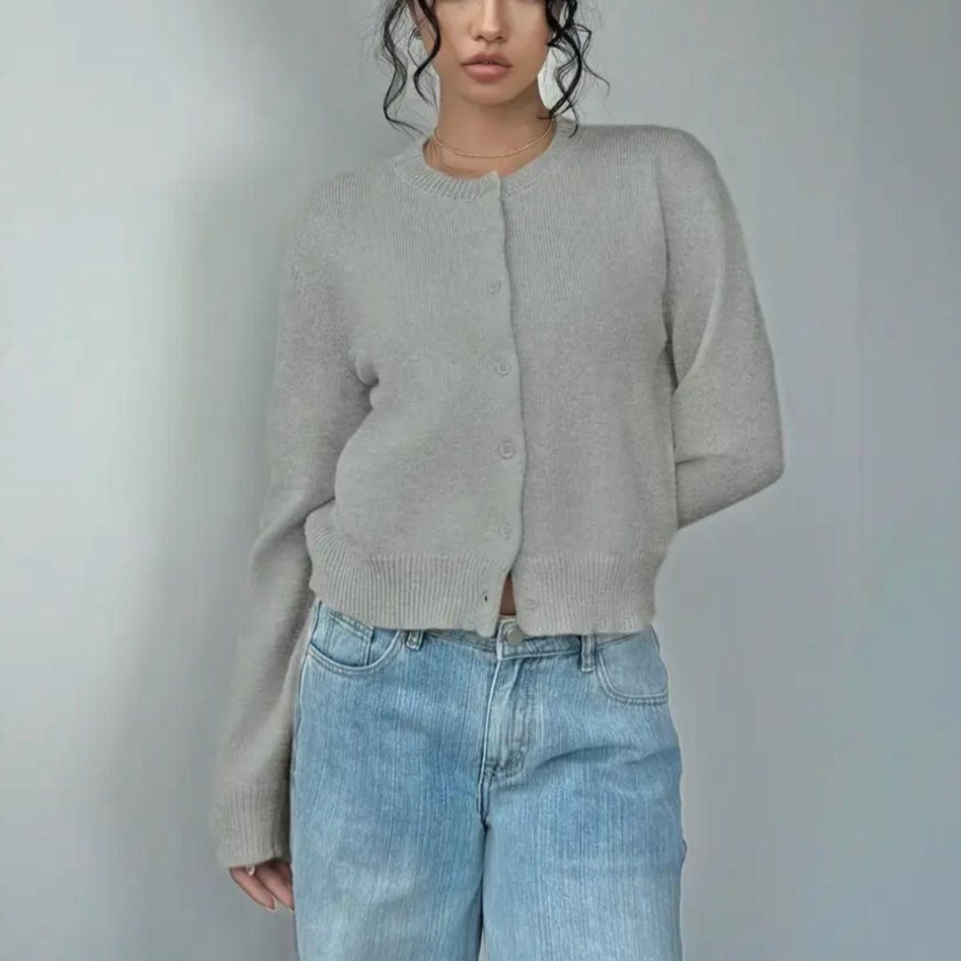 Stylish women's short cardigan. Features button closure and sophisticated ribbed trim.