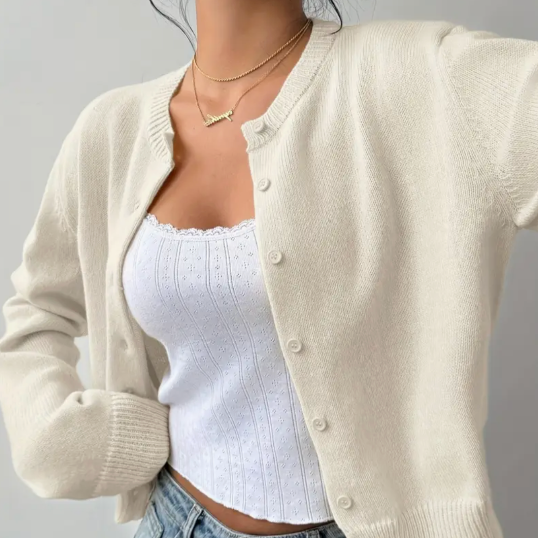 Elegant ladies' short cardigan with classic ribbed trim. Versatile layering piece.