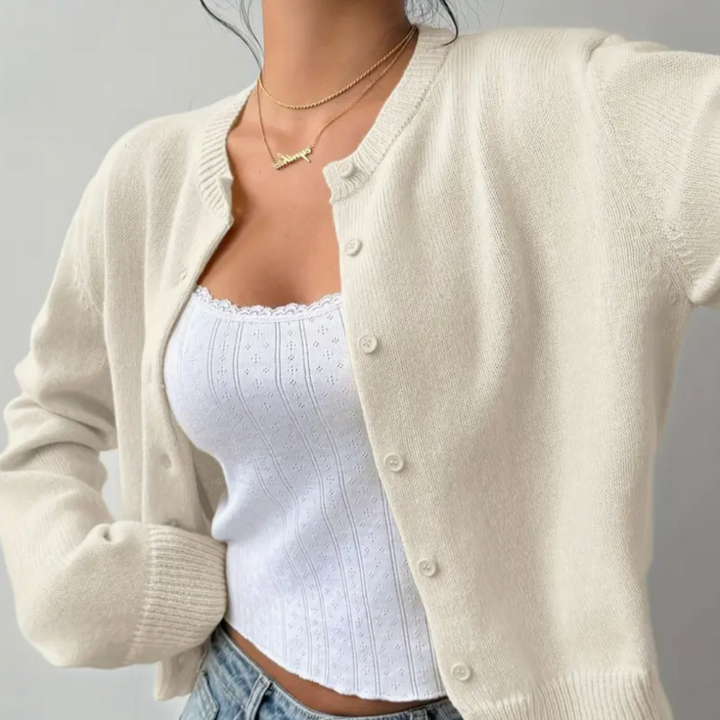 Elegant ladies' short cardigan with classic ribbed trim. Versatile layering piece.