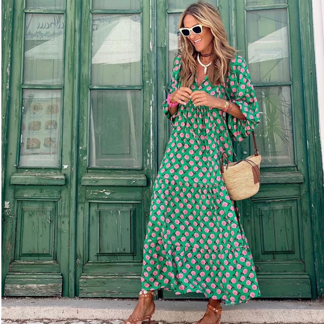 Close-up of geometric print fabric on a women's stylish high-low dress, showcasing vibrant colors and modern design.