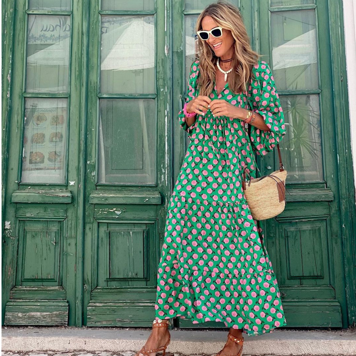 Close-up of geometric print fabric on a women's stylish high-low dress, showcasing vibrant colors and modern design.