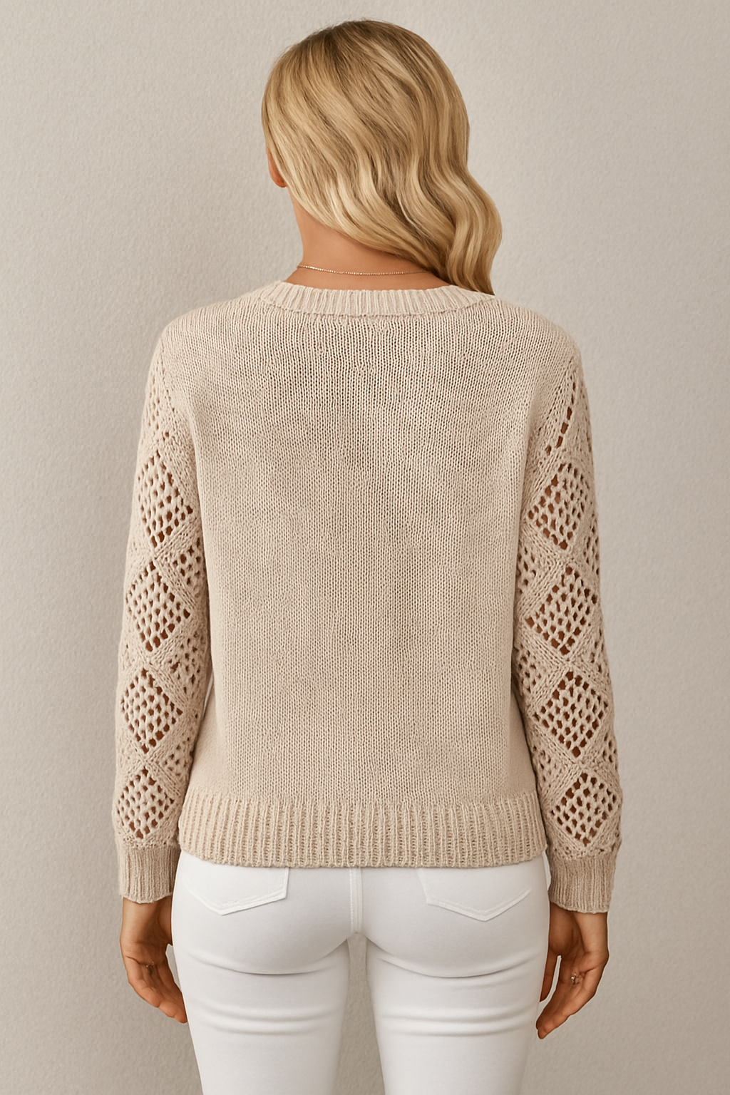 Transitional women's knit sweater with intricate crochet sleeves. Ideal for stylish layering.
