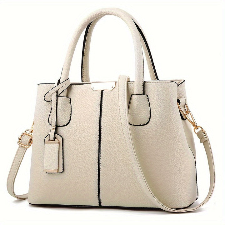 Spacious leather tote bag for women, featuring a comfortable shoulder strap, ideal for daily essentials.