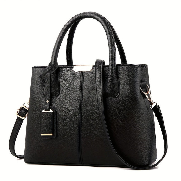 Close-up of premium textured leather on a women's fashion handbag, highlighting quality craftsmanship.