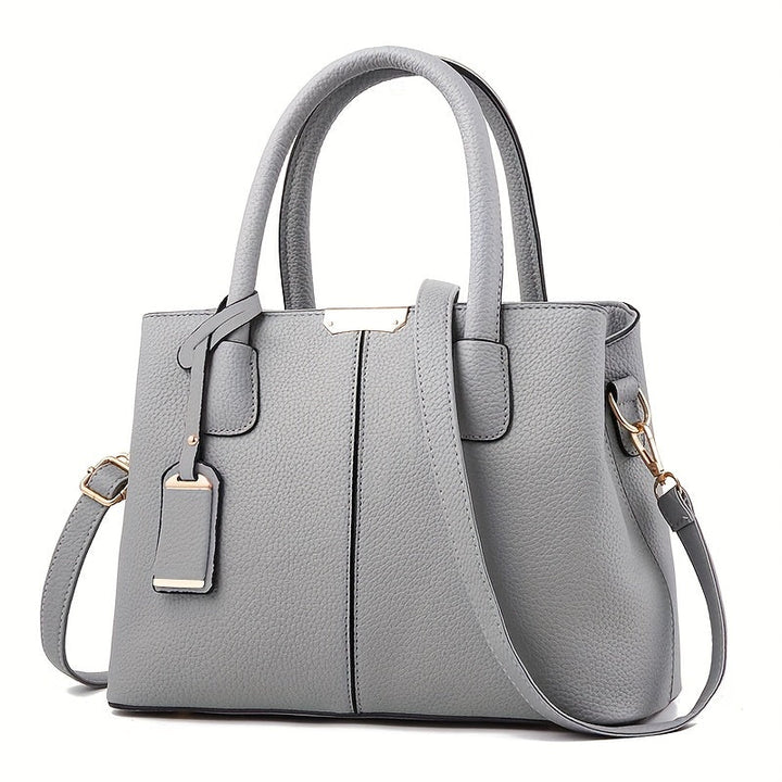 Stylish women's black leather handbag, convertible to tote or crossbody, a chic fashion accessory.